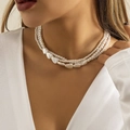 Detailed view of layered faux pearl necklace with baroque heart charm on a female model - White Multi-layer Necklace