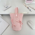 Pink canvas pen case with bow details and handle shown in a neat desktop office setting - Light Pink