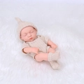 Sleeping 20cm reborn baby doll in beige knit outfit on soft white faux fur rug - Beige Knitted Style