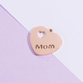Detail of rose gold heart pendant with Mom cutout design and polished metal finish - Rose Gold