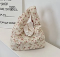Detail of floral canvas tote bag featuring delicate pink flowers and white lace trim - Red
