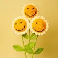 Handmade crochet sunflower bouquet with smiling face detail on vibrant yellow background - Smiley Sunflower