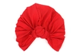 Detail of red elastic turban hat with large handmade knot on soft knitted fabric - Red