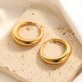 Close-up of chunky gold-plated hoop earrings on a natural stone background - Mirror Polished Chunky Hoop Style (E124)