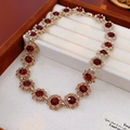 Vintage floral necklace with ruby-tone petals and champagne crystals on a golden chain - Coffee Necklace