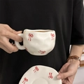 Handmade ceramic coffee cup and saucer set with red bow pattern in white finish - Double Line Bow