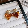 Detailed shot of amber resin heart earrings with gold metal texture in a jewelry box - Gold Irregular Metal Resin Heart Studs / Amber Ombre Heart (Silver Needle)