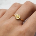 Elegant gold sunflower ring featuring detailed petals and textured center on finger - US 5 / Gold