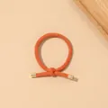 Detail of high-elastic orange braided hair tie with elegant gold metal end caps - Ribbed Knot - Metal Buckle / Orange