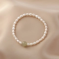 Elegant white freshwater pearl bracelet featuring a single light green gemstone bead - Pearl Bracelet with Light Green Accent Bead (J-e-016)