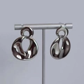 Detailed close-up of glossy silver organic drop earrings on a professional T-bar display stand - Round Disk (D314) / Silver