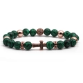 Macro shot of malachite beaded bracelet with rose gold charms and black cross pendant - Rose Gold Malachite