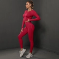 Detail of seamless magenta gym set featuring thumb-hole cuffs and ribbed high-waist band - Red