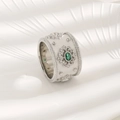 Vintage silver ring featuring an oval emerald green gemstone and intricate beadwork accents - US 6 / White Gold