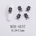 Macro detail of silver skull and crossbones nail charms with model MZH-AE57 on fake nails - AE57-Skull and Crossbones