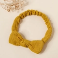 Detailed texture of ginger yellow cotton baby headband with a large elastic bow - Ginger Yellow