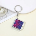 Detailed top view of a square metal keychain featuring sparkling pink and blue rhinestones - Two Colors