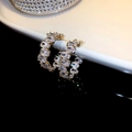 Macro shot of gold C-shaped earrings featuring luxury micro-paved oval zircon stones - 32# Silver Needle-Gold (Crystal C-shape)