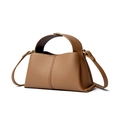 Detailed view of the brown pebble leather texture and sturdy handle on this square handbag - Biscuit