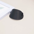 Black embossed leather hair tie with floral pattern and elastic band on beige background - Black Embossed
