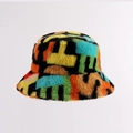 Close-up of plush bucket hat featuring multi-color abstract geometric patchwork patterns - Colorful Letters