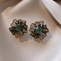 Vintage flower earrings with emerald green stone and golden textured metal petals - Antique Gold Emerald Style