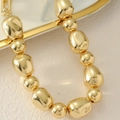 Chunky gold punk choker featuring high-polished irregular beads and spheres - Gold