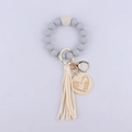Detail of grey silicone bead keychain with golden Mama charm and beige tassel - Light Gray