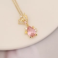 Close-up of pink gemstone fish pendant on gold chain necklace over ceramic dish - Fish Shape Pink Teardrop Gem (8#)