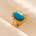 Close-up of vintage gold adjustable ring featuring a textured blue turquoise stone - Gold + Ink Blue