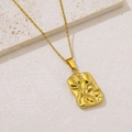 Detail of gold rectangular pendant with wrinkled texture on a beige marble surface - Irregular Crinkled Rectangle (NKS-002_09)