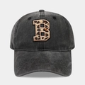 Detail of embroidered leopard print letter B on washed black denim baseball cap - Leopard Alphabet B Pattern