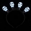 Halloween headband with four glowing white LED skulls on a black frame accessory - Skull Headband