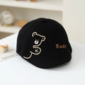 Detail shot of a black cotton kids' beret with cute bear embroidery on a white table - 50cm (1-3 Years) / Black