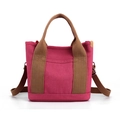 Deep pink canvas tote bag with brown straps, versatile shoulder and crossbody style - Red