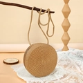 Natural round straw crossbody bag featuring spiral weave and woven shoulder strap - 16cm / Brown