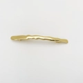 Macro view of gold wavy alloy spring hair clip with a smooth metallic finish and back structure - Gold Wave Style