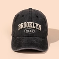 Close-up of vintage washed cotton baseball cap with Brooklyn 1947 3D embroidery detail - Black