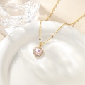 Detail of pink heart-shaped crystal necklace with pavé diamond halo in gold finish - Pink Pendant Necklace