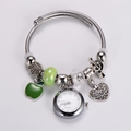 Detail view of silver Pandora style bracelet with apple pendant and mini quartz watch - Green Apple Style