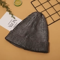 Close-up of metallic dark grey knit beanie with silver lurex on stylized yellow background - Antique Silver