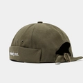 Detail of army green docker hat featuring white 'absolutely not' embroidery and metal buckle - Army Green
