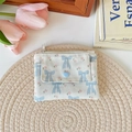 Close-up of fabric coin purse with blue bow, floral patterns and heart-shaped clasp - Blue Bowknot