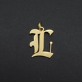 Detailed close-up of a golden gothic letter L pendant with a polished metal finish - L