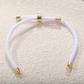 Close-up of white braided Milan cord bracelet with adjustable gold-plated slider clasp - White