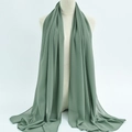 Sage green lightweight chiffon hijab scarf with elegant drape on a display mannequin - 74