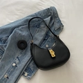 Classic black crescent shoulder bag with gold hardware and extra strap on denim jacket - Black