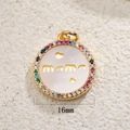 Macro view of a 16mm gold Mama heart pendant with colorful zircons and white shell - Mama Shell (A0054)
