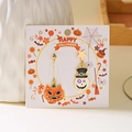 Detail of asymmetric Halloween earrings with pumpkin cat and skull charms on card - Pumpkin Cat and Skull Style (ER24Y0406)
