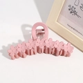 Detail of pink 13cm flower hair claw clip with matte finish on minimalist white background - Pink